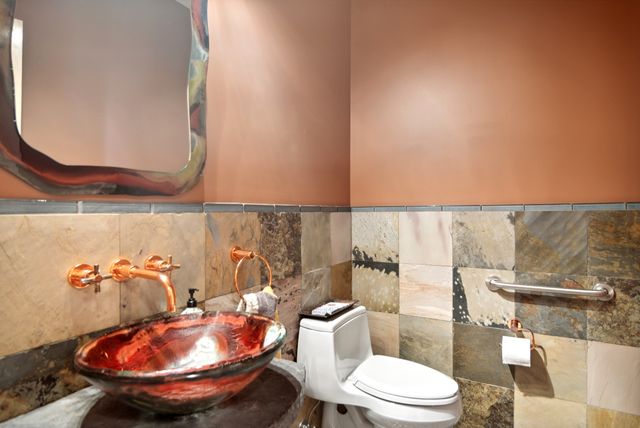 a bathroom with a toilet a sink and a mirror