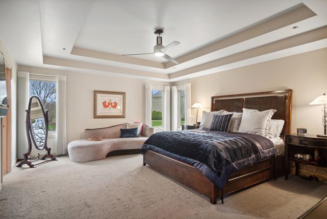 a bedroom with a bed couch and a window