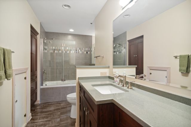 a bathroom with a sink double vanity granite tub and shower
