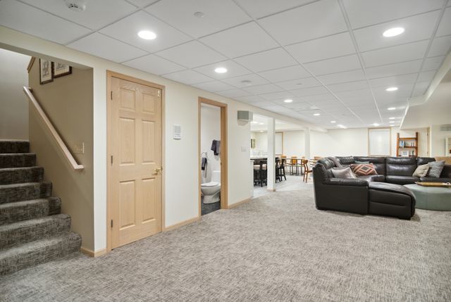 a living room with furniture and a ceiling fan