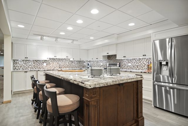 a kitchen with center island table and chairs