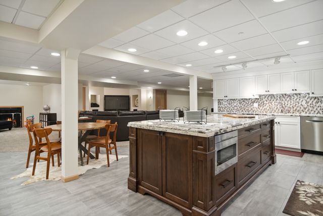 a kitchen with a stove and a white cabinets