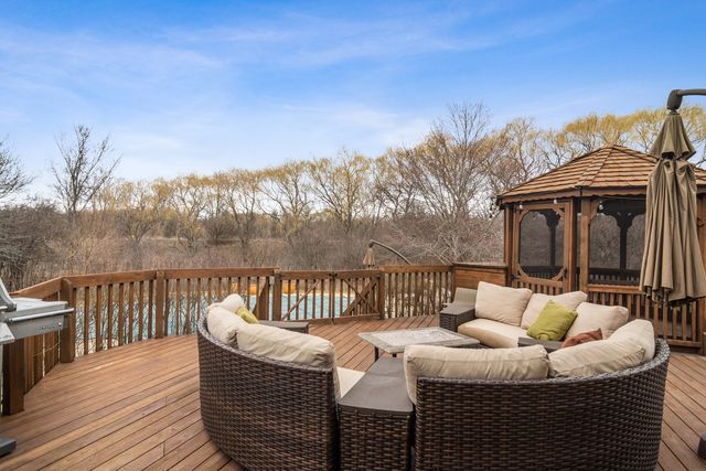 a balcony with furniture and wooden floor
