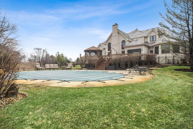 a front view of a house with swimming pool and porch