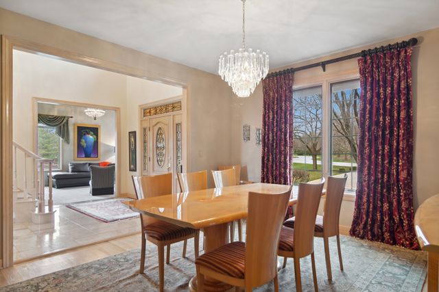 a view of a dining room with furniture wooden floor and chandelier
