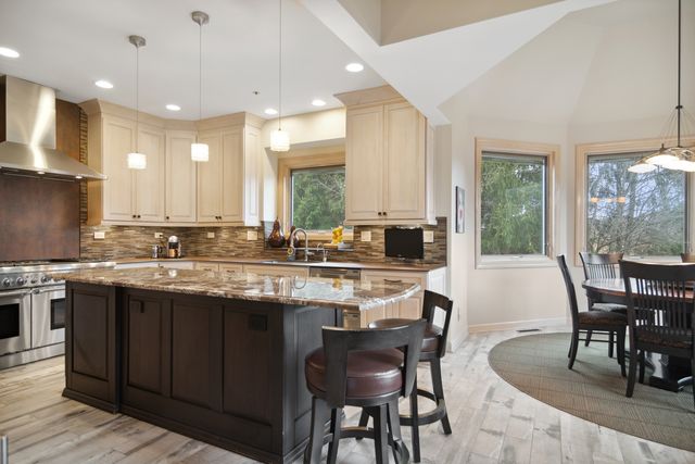 a kitchen with center island table and chairs in it