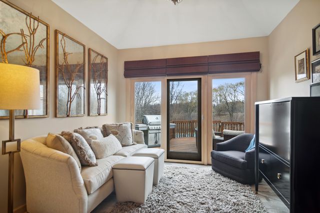 a living room with furniture and a floor to ceiling window