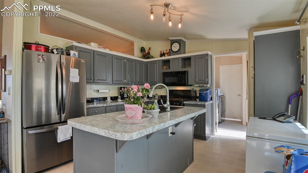 34475 East Jones Road Yoder, CO 80864 - Photo 6 of 37 a kitchen with refrigerator and microwave