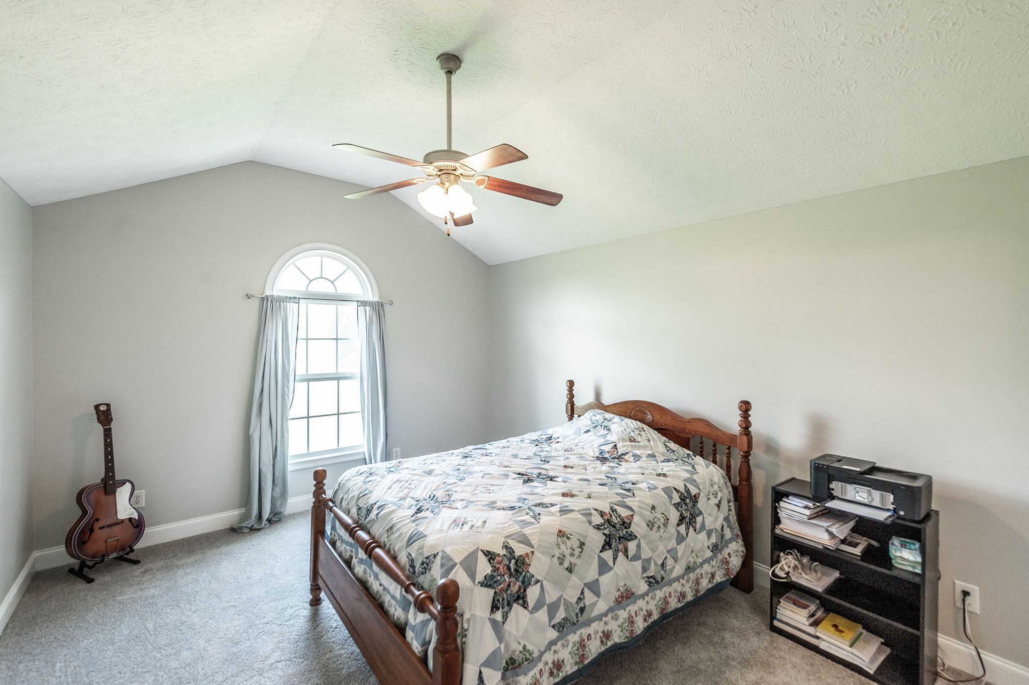 128 Old Fountain Head Cemetary Road Portland, TN 37148 - Photo 29 of 58 a bedroom with a bed and a chandelier
