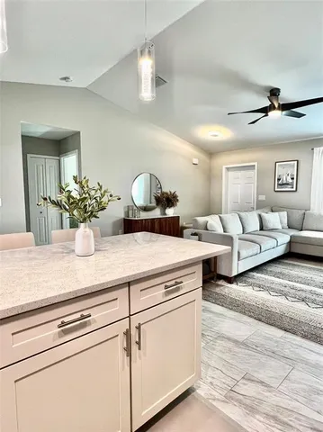 a living room with furniture potted plant and white walls