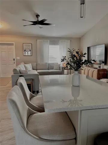 a living room with furniture and a potted plant