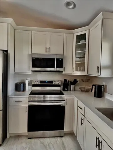 a kitchen with a stove and a microwave