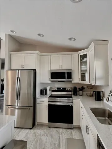 a kitchen with a refrigerator stove and sink