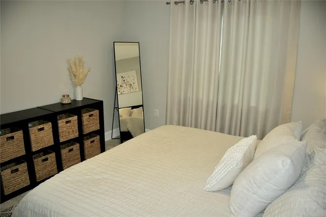 a bedroom with a bed and a window