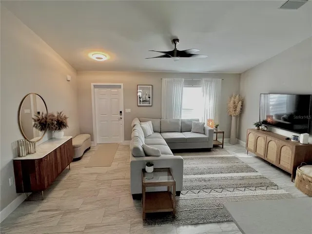 a living room with furniture and a mirror