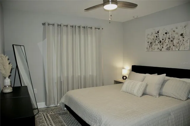 a bedroom with a bed and a chandelier