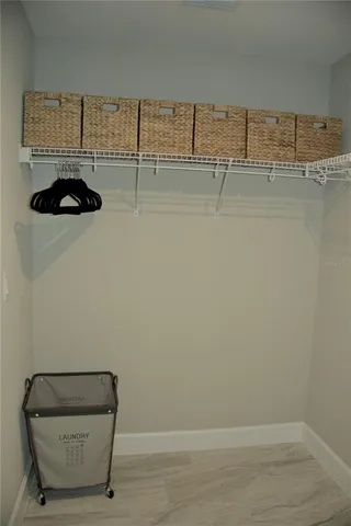 a room with water heater and racks on the wall