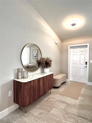 a living room with furniture a rug and a window