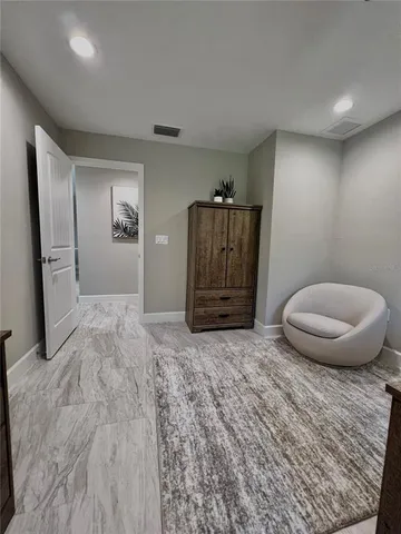 a view of a livingroom with a chair and cabinet