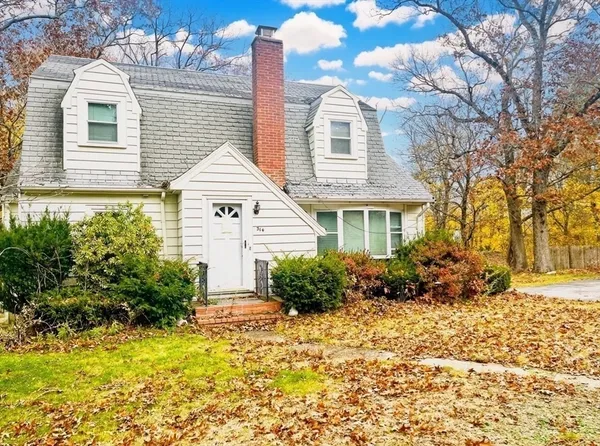 a view of a house with a yard and garden
