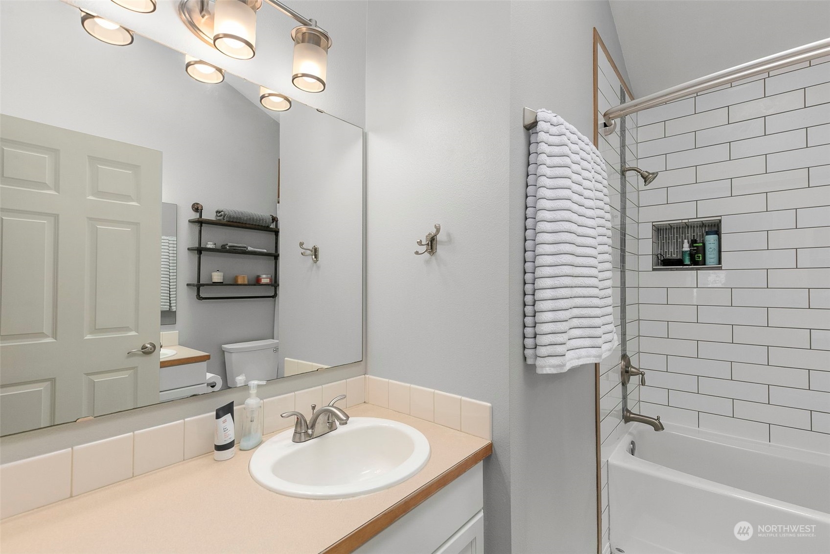 1522 196th Street Southeast, Unit G101 Bothell, WA 98012 - Photo 21 of 29 a bathroom with a sink a bathtub and a mirror