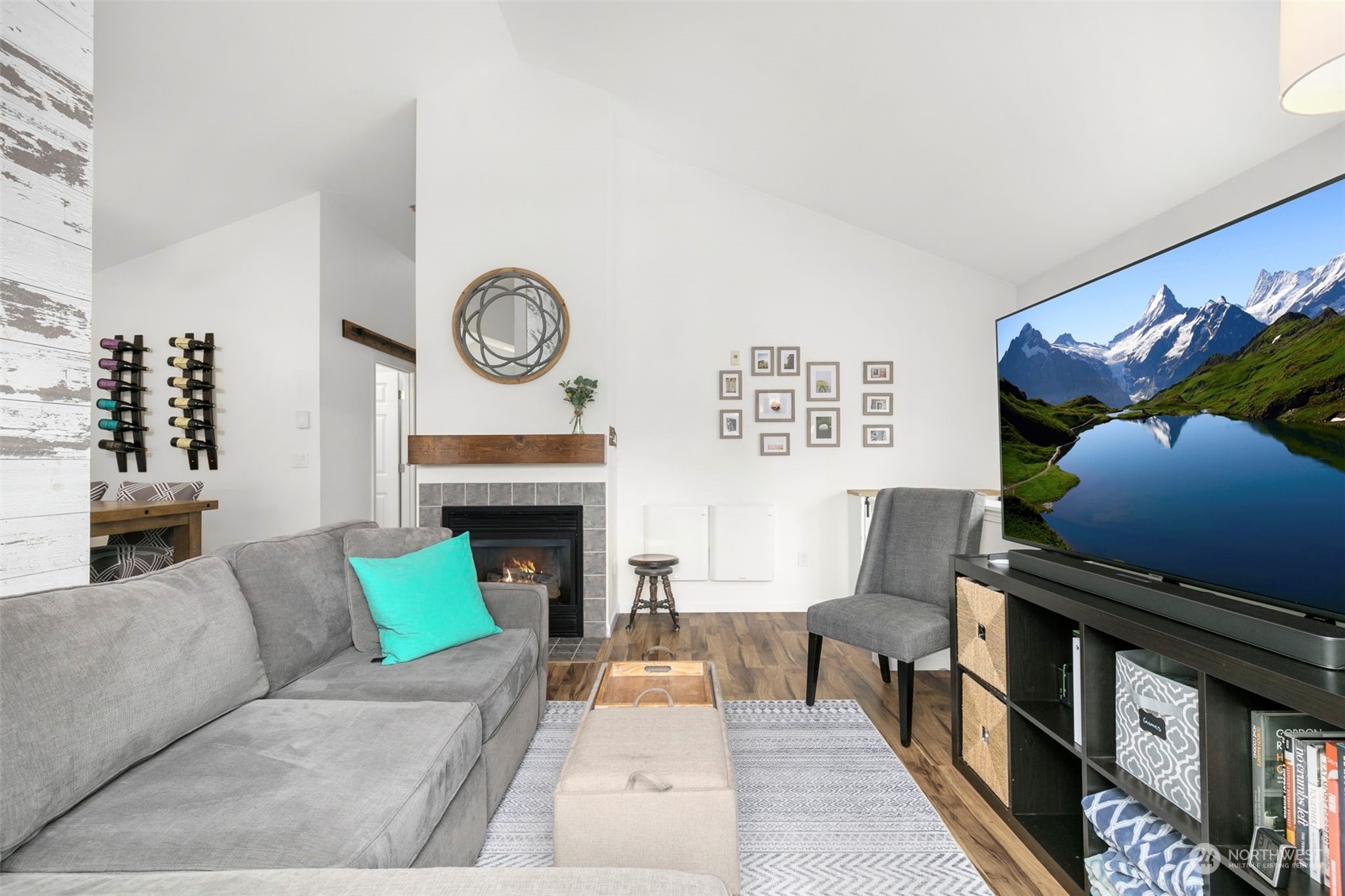 1522 196th Street Southeast, Unit G101 Bothell, WA 98012 - Photo 8 of 29 a living room with furniture a fireplace and a wall painting