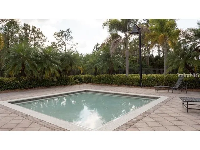 a view of swimming pool with a table and chairs