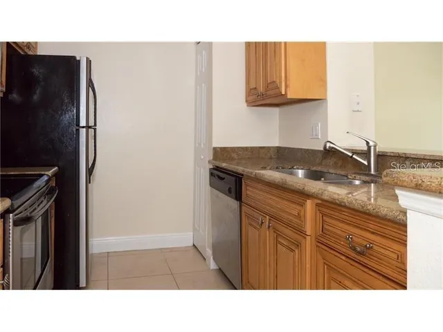 a kitchen with a refrigerator and a sink