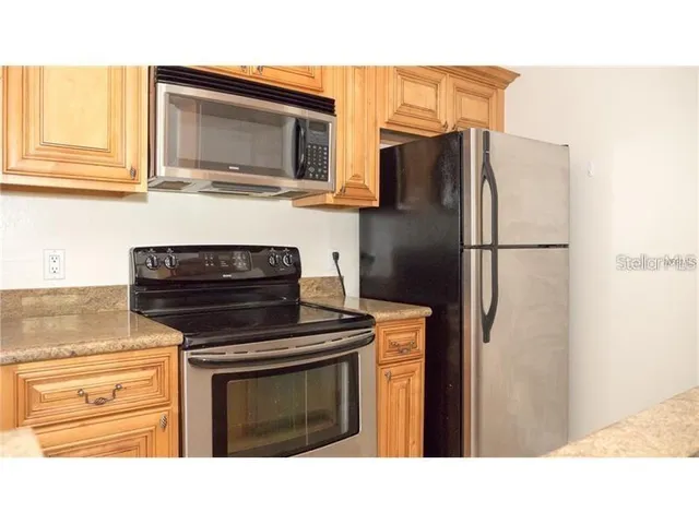 a kitchen with a refrigerator stove and microwave