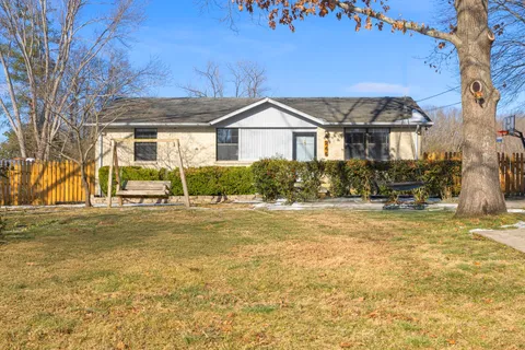 a view of house with a yard