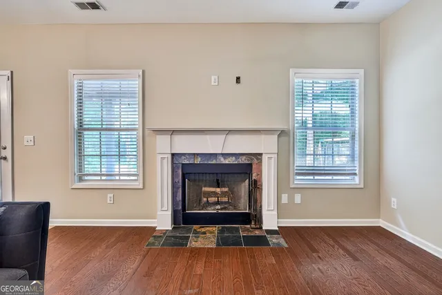 a living room with a fireplace with wooden floor