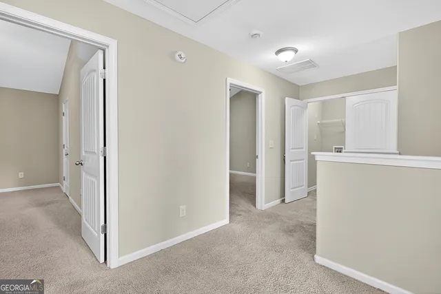 a view of a hallway with closet and cabinet