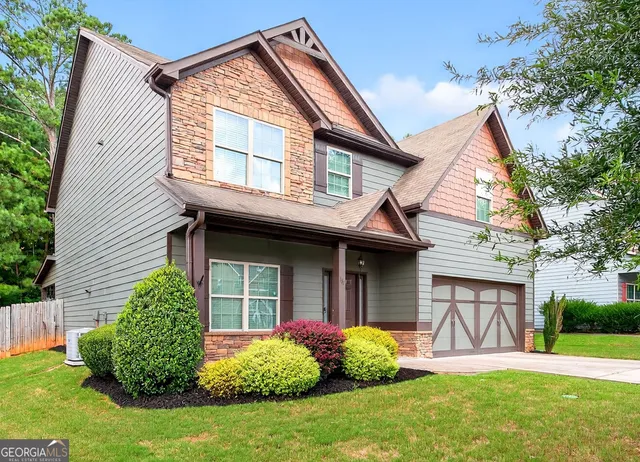 a view of a house with a yard and plants
