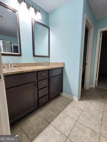 a bathroom with a double vanity sink and mirror