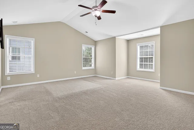 a view of a livingroom with a ceiling fan and window