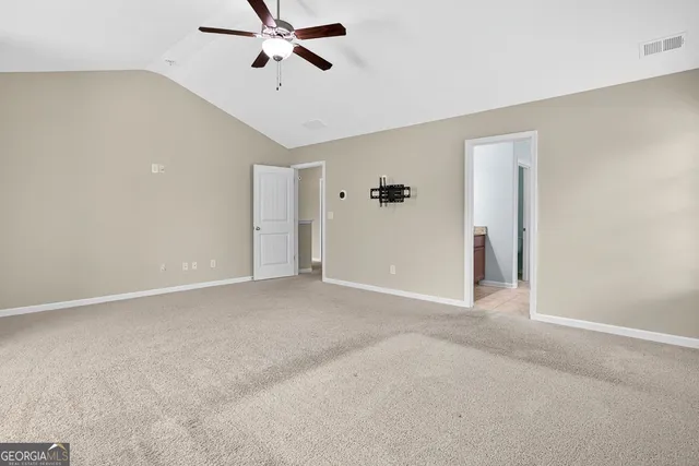 a view of a room with a ceiling fan
