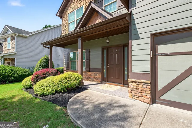 a front view of a house with garden