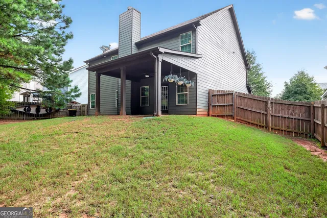 a view of a house with a yard and porch