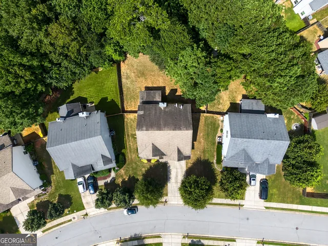 an aerial view of multiple houses with yard