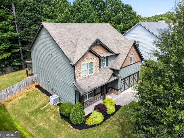 a aerial view of a house with yard and sitting area
