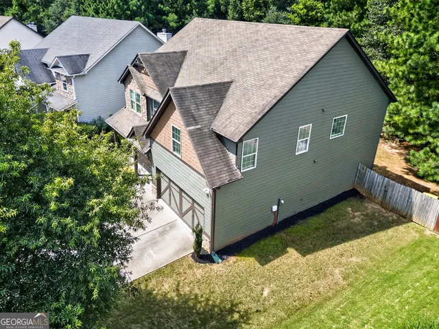 an aerial view of a house with a yard