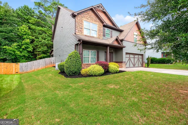 a front view of a house with garden