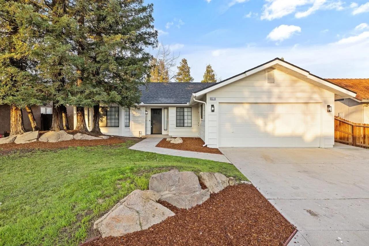 a backyard of a house with table and chairs