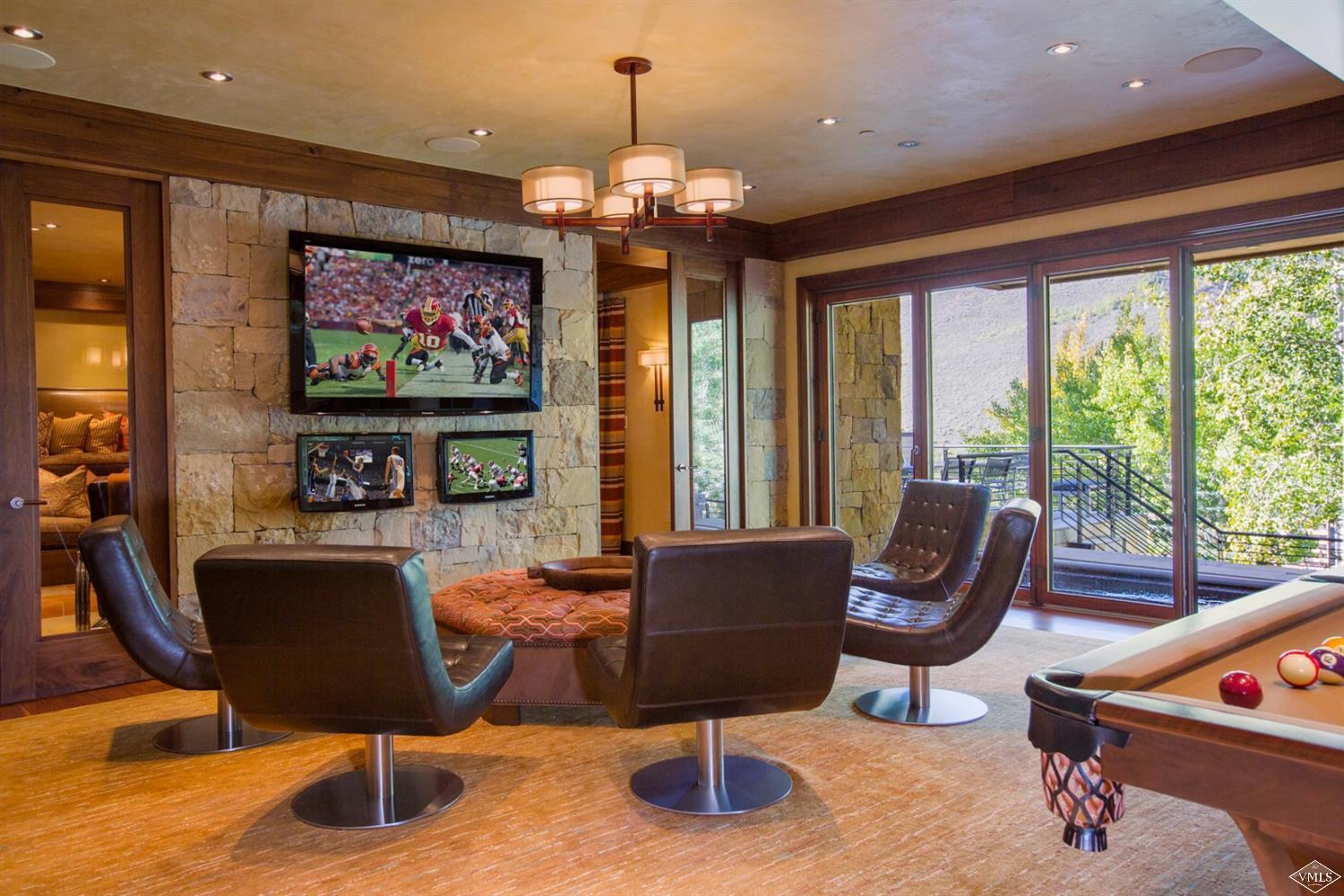 107 Rockledge Road Vail, CO 81657 - Photo 3 of 4 a living room with furniture a flat screen tv and a large window