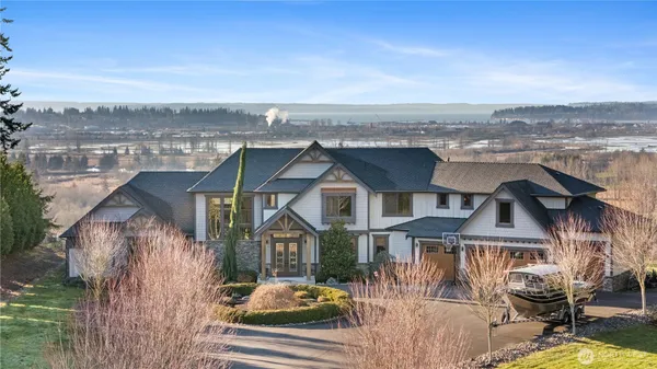 an aerial view of residential houses with outdoor space and river