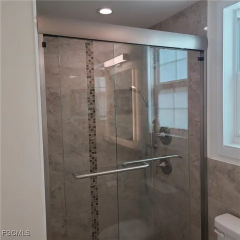 a bathroom with a shower and a mirror