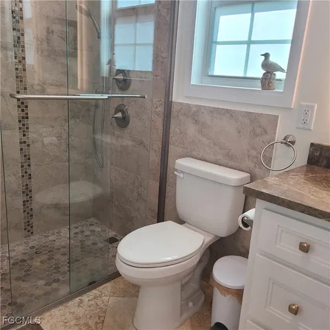a white toilet sitting next to a bathroom sink