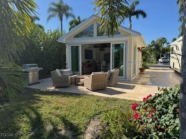 a view of a house with backyard sitting area and garden