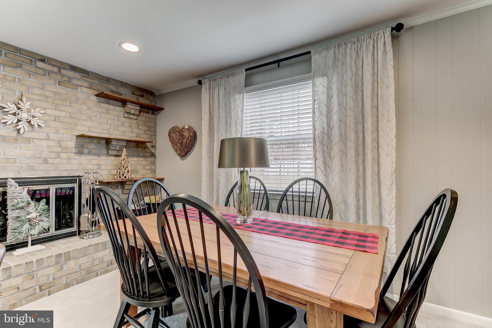 7928 Long Meadow Road Baltimore, MD 21208 - Photo 15 of 34 Inviting wood-burning fireplace with brick hearth