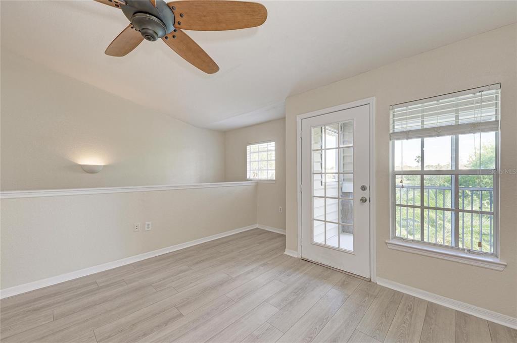 8911 Manor Loop, Unit 207 Lakewood Ranch, FL 34202 - Photo 13 of 71 a view of an empty room with a window and wooden floor